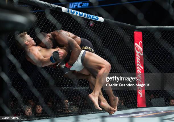 Tyron Woodley takes down Stephen Thompson in their welterweight championship bout during the UFC 209 event at T-Mobile arena on March 4, 2017 in Las...