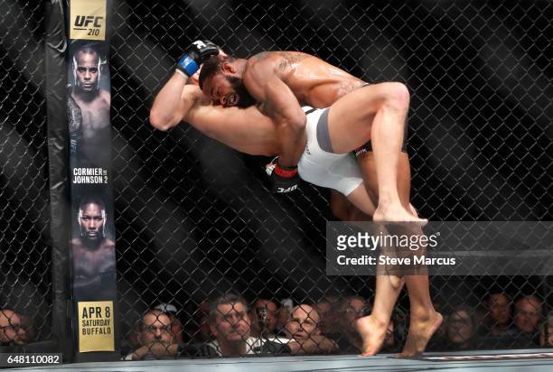 Welterweight champion Tyron Woodley, top, takes Stephen Thompson to the mat in their title fight during UFC 209 on March 4, 2017 in Las Vegas,...