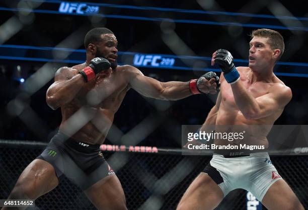 Tyron Woodley punches Stephen Thompson in their welterweight championship bout during the UFC 209 event at T-Mobile arena on March 4, 2017 in Las...
