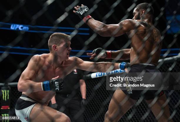 Stephen Thompson punches Tyron Woodley in their welterweight championship bout during the UFC 209 event at T-Mobile arena on March 4, 2017 in Las...