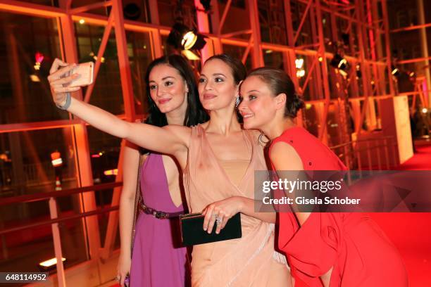 Maria Ehrich, Emilia Schuele and Sonja Gerhardt take a selfie during the Goldene Kamera reception at Messe Hamburg on March 4, 2017 in Hamburg,...