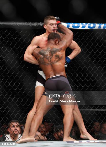 Welterweight champion Tyron Woodley pushes Stephen Thompson against the Octagon fence during his title defense at UFC 209 on March 4, 2017 in Las...