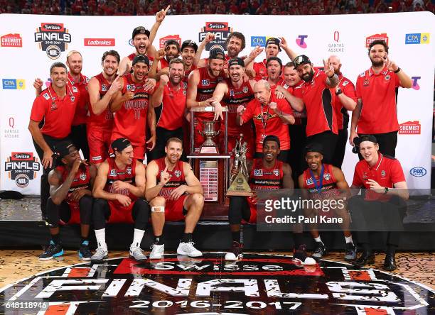 The Wildcats celebrate with the trophy after winning game three and the NBL Grand Final series between the Perth Wildcats and the Illawarra Hawks at...