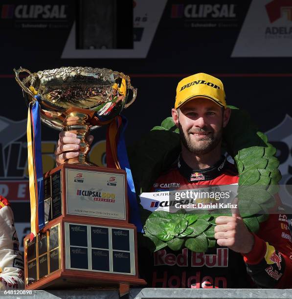 Shane Van Gisbergen driver of the Red Bull Holden Racing Team Holden Commodore VF celebrates after winning race 2 for the Clipsal 500, which is part...
