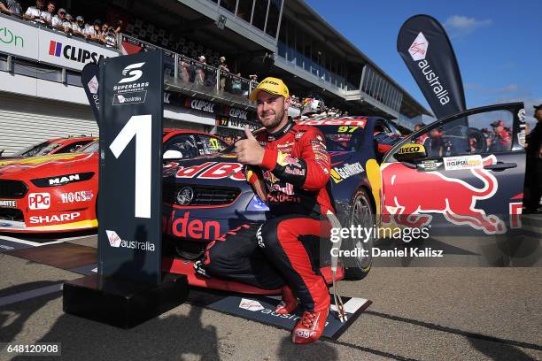 Shane Van Gisbergen driver of the Red Bull Holden Racing Team Holden Commodore VF celebrates after winning race 2 for the Clipsal 500, which is part...