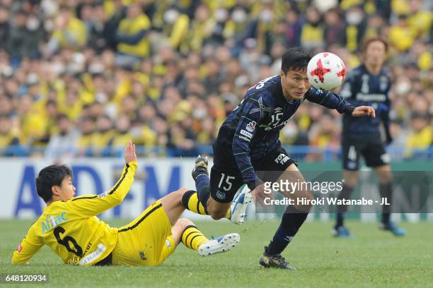 Yasuyuki Konno of Gamba Osaka goes past the tackle by Yusuke Kobayashi of Kashiwa Reysol during the J.League J1 match between Kashiwa Reysol and...