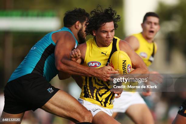 Daniel Rioli of the Tigers is tackled by Paddy Ryder of the Power during the 2017 JLT Community Series AFL match between the Port Adelaide Power and...