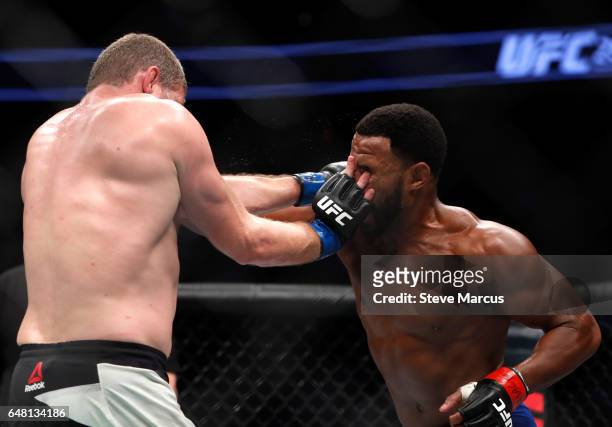 Middleweight Daniel Kelly of Australia fends off Rashad Evans during UFC 209 at T-Mobile Arena on March 4, 2017 in Las Vegas, Nevada. Kelly won the...