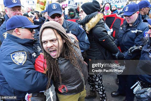 The protesters were seized by the policemen. An estimated one thousand activists gathered in front of the New York City Public Library Main Branch...