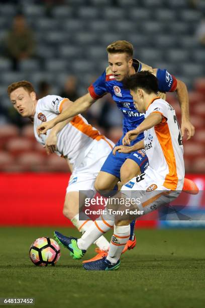 Andrew Hoole of the Jets contests the ball with Joe Caletti of the Roar during the round 22 A-League match between the Newcastle Jets and the...