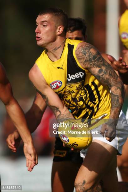 Dustin Martin of the Tigers passes the ball during the 2017 JLT Community Series AFL match between the Port Adelaide Power and the Richmond Tigers at...