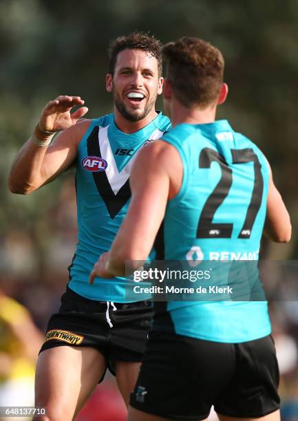 Travis Boak of the Power celebrates with Brett Eddy of the Power after Eddy kicked a goal during the 2017 JLT Community Series AFL match between the...