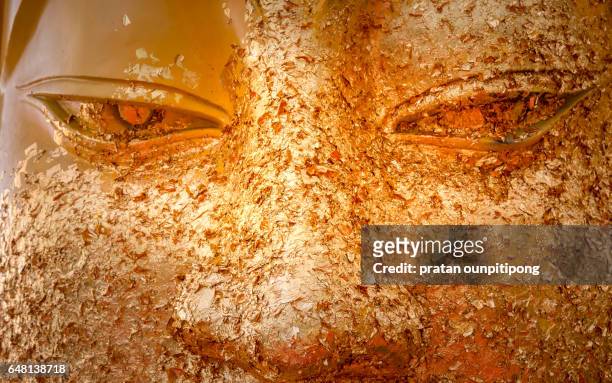 the golden buddha face - buddha face stock-fotos und bilder