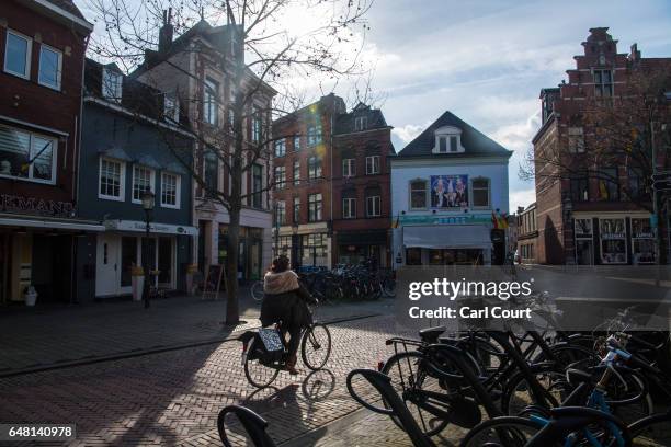 Woman cycles past shops on February 21, 2017 in Venlo, Netherlands. The Dutch will vote in parliamentary elections on March 15 in a contest that,...