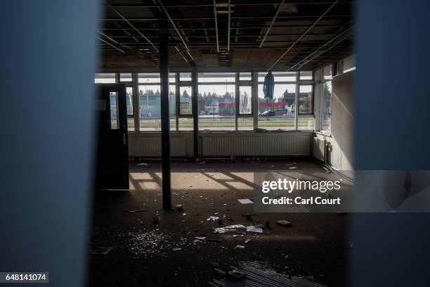 Broken glass and uncleared items lay on the floor of a disused customs clearance building on the Dutch - German border on February 21, 2017 in Venlo,...