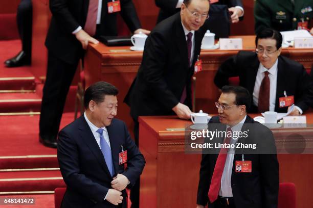 Premier Li Keqiang talk with Chinese President Xi Jinping after the opening session of the National People's Congress at The Great Hall of People on...