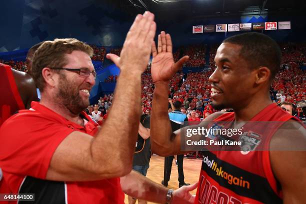 Trevor Gleeson, coach of the Wildcats, and Bryce Cotton celebrate after winning game three and the NBL Grand Final series between the Perth Wildcats...