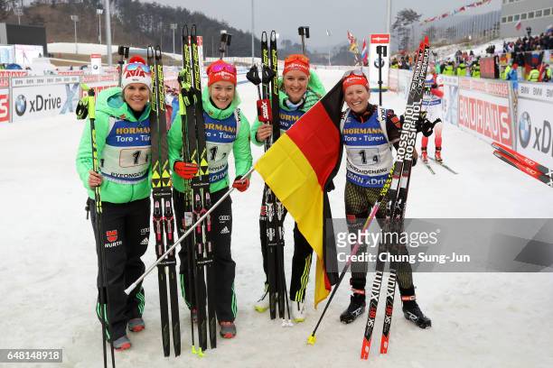 Franziska Hildebrand, Nadine Horchler, Maren Hammerschmidt and Denise Herrmann of Germany celebrates after winning the Women's 4x6km relay during the...