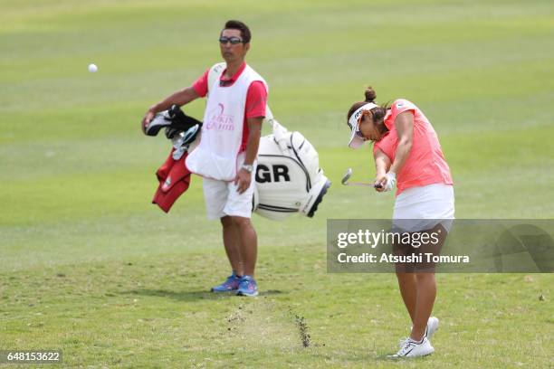 Asako Fujimoto of Japan hits her second shot on the 12th hole during the final round of the Daikin Orchid Ladies Golf Tournament at the Ryukyu Golf...