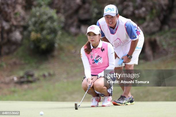 Bo-Mee Lee of South Korea lines up her putt on the 14th hole during the final round of the Daikin Orchid Ladies Golf Tournament at the Ryukyu Golf...