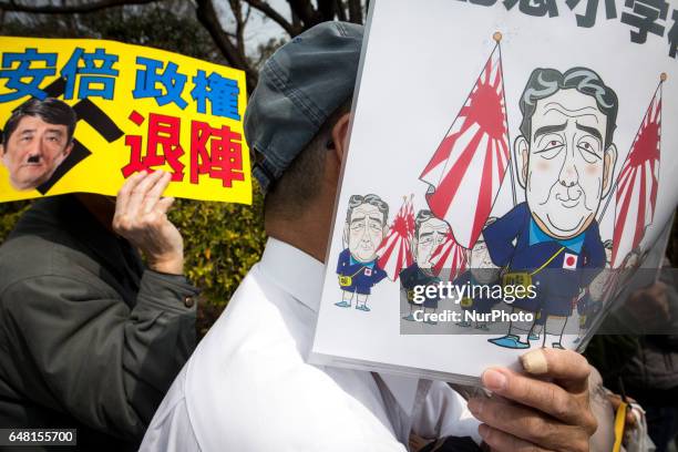 Anti-Abe protesters with placards reading &quot;Abe government, leave out!&quot; gather in front of the National Diet Building to protest against the...