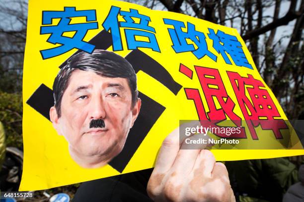 Anti-Abe protesters with placards reading &quot;Abe government, leave out!&quot; gather in front of the National Diet Building to protest against the...