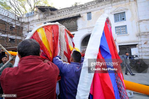 Members of Manandhar Guthi community arranging ceremonial Bamboo Log know as &quot;Chir&quot; along with the vibrant cloth strips, which representing...