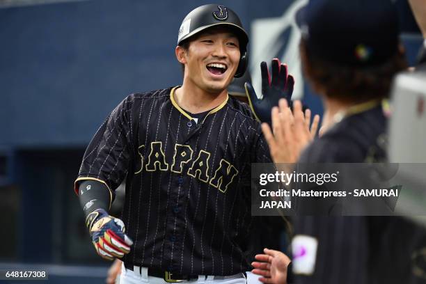 Outfielder Seiya Suzuki of Japan high fives with his team mates after hitting a three-run homer in the top of the second inning during the World...