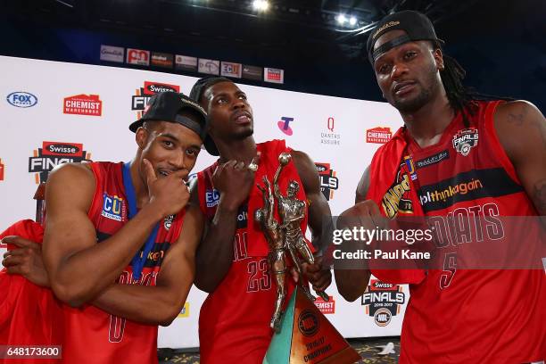 Bryce Cotton, Casey Prather and Jameel McKay of the Wildcats pose with their rings and the championship trophy after winning game three and the NBL...