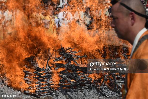 Buddhist monks pray in front of a big fire during the Nagatoro Hi-Matsuri or fire-walking festival, to herald the coming of spring, at the Fudoji...