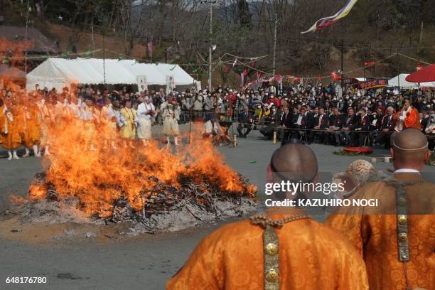 Buddhist monks pray in front of a big fire during the Nagatoro Hi-Matsuri or fire-walking festival, to herald the coming of spring, at the Fudoji...