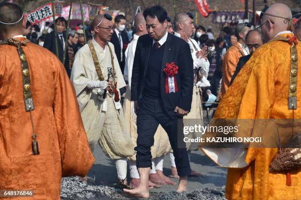 Buddhism believer takes part in the Nagatoro Hi-Matsuri or fire-walking festival, to herald the coming of spring, at the Fudoji temple in Nagatoro...