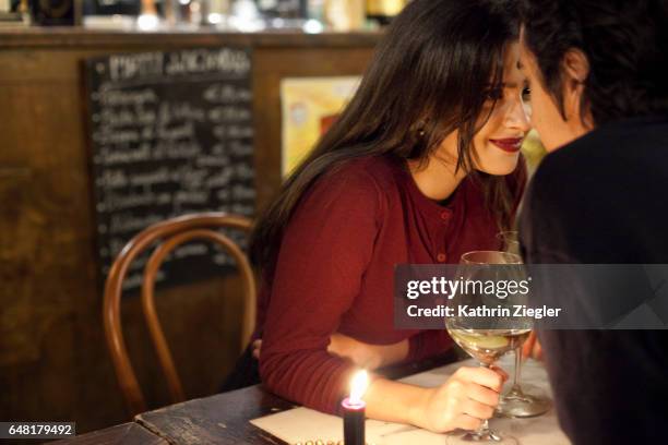 young couple having a romantic moment at a restaurant, rome, italy - mesa para dos fotografías e imágenes de stock