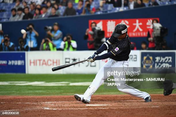Pinch hitter Shogo Akiyama of Japan hits a two-run triple in the top of the ninth inning during the World Baseball Classic Warm-Up Game between Japan...