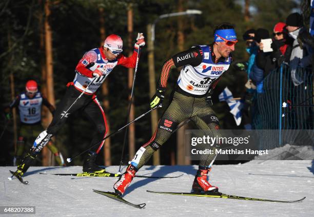 Keishin Yoshida of Japan and Jonas Dobler of Germany compete in the Men's Cross Country Mass Start during the FIS Nordic World Ski Championships on...