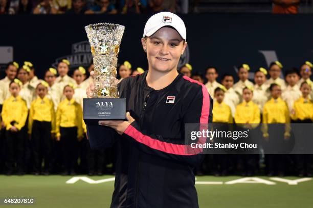 Ashleigh Barty of Australia poses with the WTA Malaysian Open Champion Trophy after she defeated Nao Hibino of Japan during the Final of the 2017 WTA...