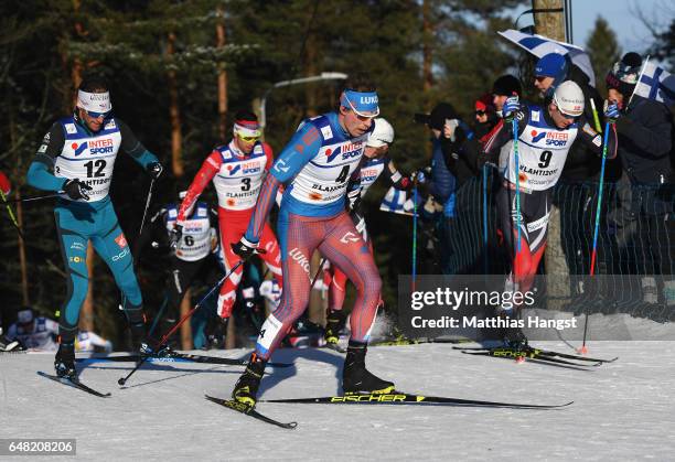 Jean Marc Gaillard of France , Sergey Ustiugov of Russia and Sjur Roethe of Norway compete in the Men's Cross Country Mass Start during the FIS...