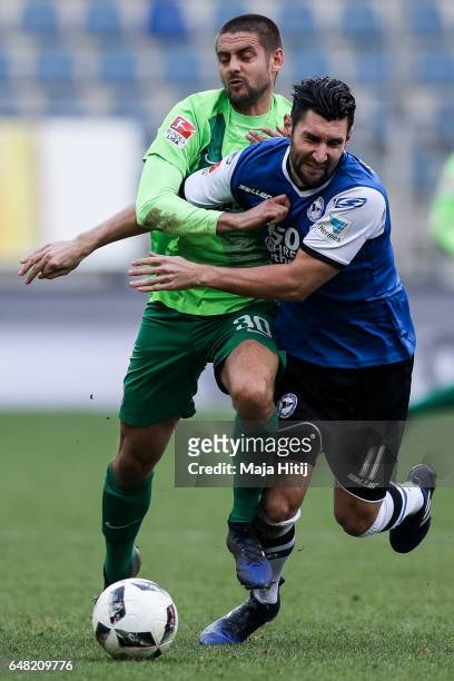 Stephan Salger of Bielefeld and Dimitrij Nazarov battle for the ball during the Second Bundesliga match between DSC Arminia Bielefeld and FC...