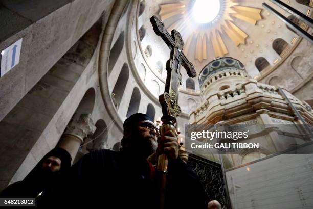Greek Orthodox clergy carry a processional cross as they circle the Edicule at the Church of the Holy Sepulchre in Jerusalems old city during the...