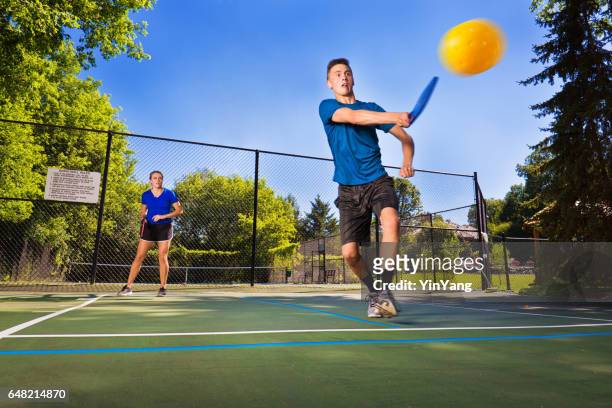 two young teenagers playing pickle ball - doubles sports stock pictures, royalty-free photos & images