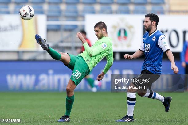 Stephan Salger of Bielefeld and Dimitrij Nazarov of Aue battle for the ball during the Second Bundesliga match between DSC Arminia Bielefeld and FC...