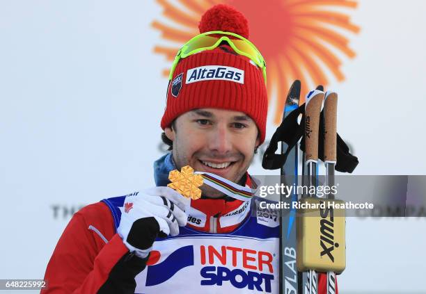 Alex Harvey of Canada celebrates winning the gold medal in the Men's Cross Country Mass Start during the flower ceromeny during the FIS Nordic World...