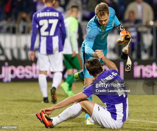 David Kalnoki Kis of Ujpest FC shake hands with goalkeeper Denes Dibusz of Ferencvarosi TC during the Hungarian OTP Bank Liga match between Ujpest FC...