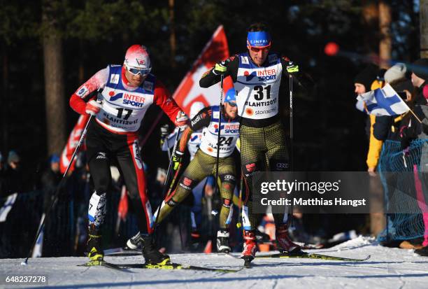 Keishin Yoshida of Japan and Jonas Dobler of Germany compete in the Men's Cross Country Mass Start during the FIS Nordic World Ski Championships on...