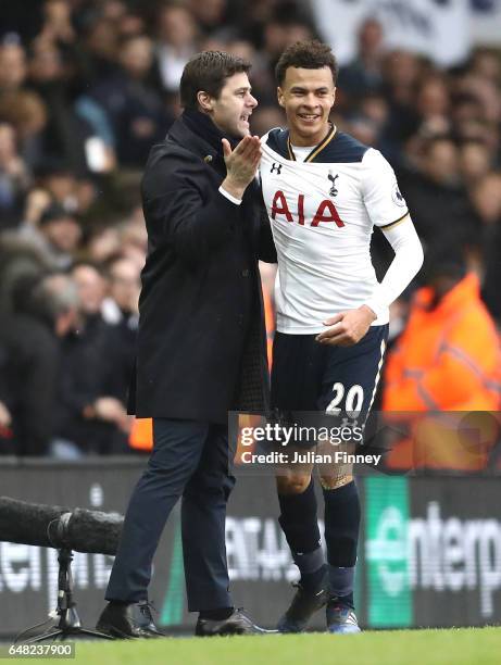 Dele Alli of Tottenham Hotspur celebrates with Mauricio Pochettino, Manager of Tottenham Hotspur after scoring his sides third goal during the...