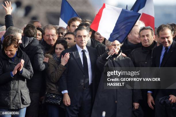 French presidential election candidate for the right-wing Les Republicains party Francois Fillon holds by the shoulder his wife Penelope Fillon and...