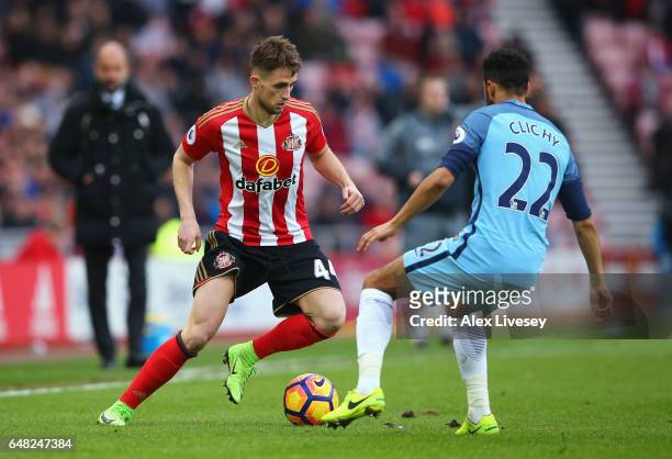 Adnan Januzaj of Sunderland attempts to take the ball past Gael Clichy of Manchester City during the Premier League match between Sunderland and...