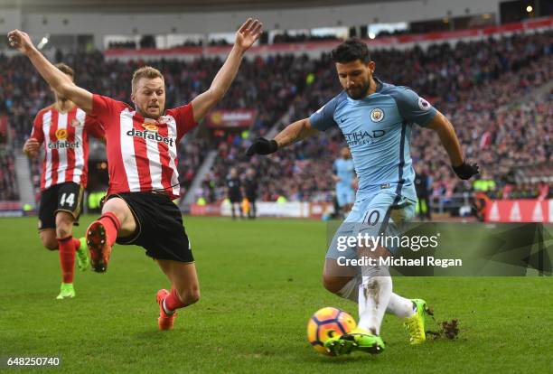 Sebastian Larsson of Sunderland attempts to block Sergio Aguero of Manchester City cross during the Premier League match between Sunderland and...