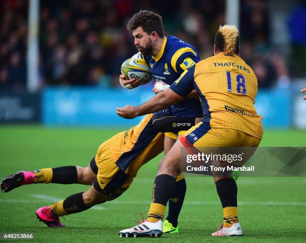 Wynand Olivier of Worcester Warriors is tackled by Tusi Pisi and Jamal Ford-Robinson of Bristol Rugby during the Aviva Premiership match between...