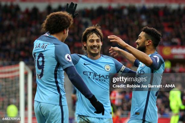 Leroy Sane of Manchester City celebrates scoring the second goal to make the score 0-2 with team-mates David Silva and Gael Clichy during the Premier...